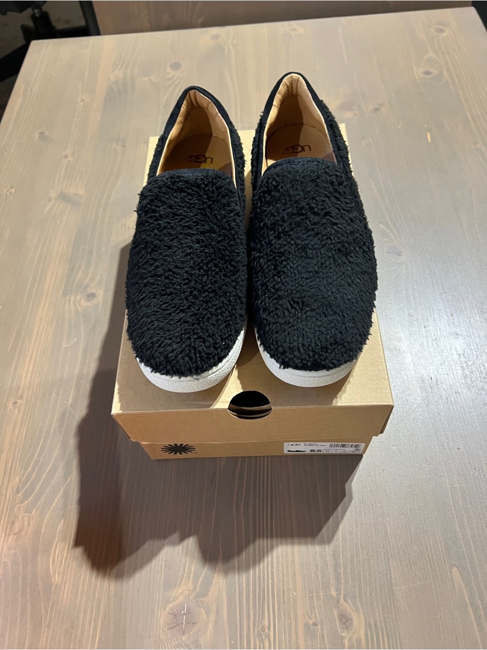 UGG Black Fuzzy Slip-On Sneakers with White Sole